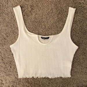 White ribbed crop top with ruffled bottom edges
